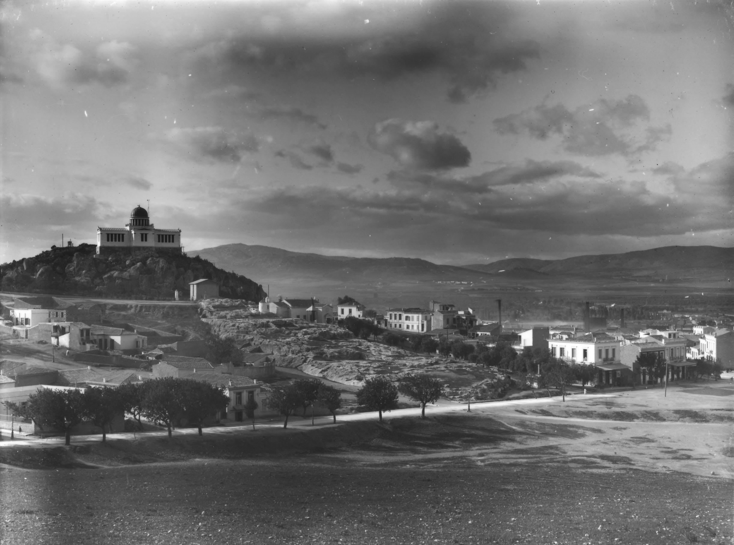 The Observatory and the cuttings of the Archaic shrine of Zeus, in the middle, along with the newly built structures before 1927, the year the contemporary Agia Marina was erected (Nicholson Museum, Professor W.J. Woodhouse Collection).